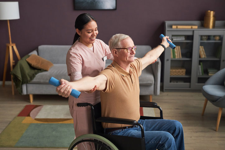 helping senior with his exercises