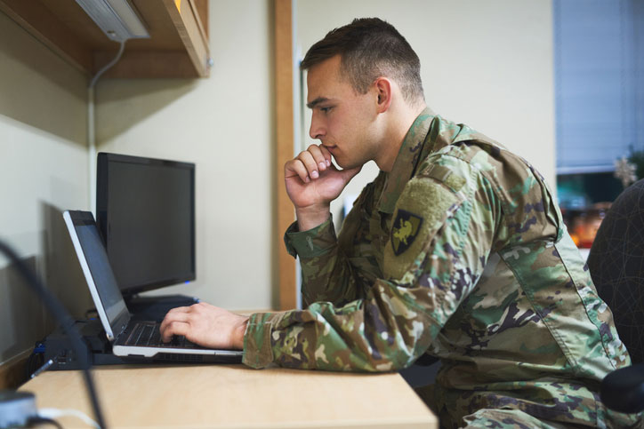 soldier concentrating on laptop